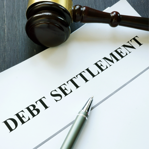Debt settlement agreement papers with gavel representing hidden risks in Orange County, CA